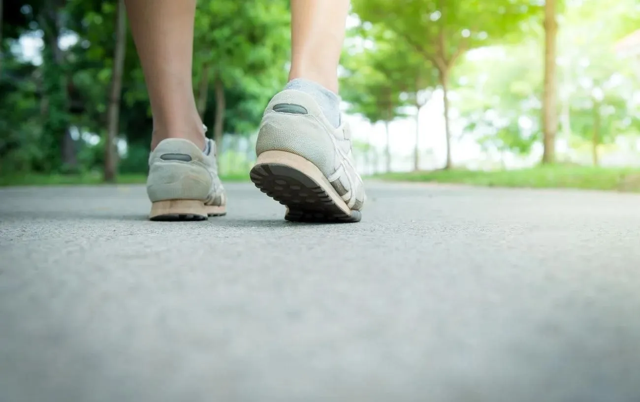 Человек крупным планом's sneakers taking a step.