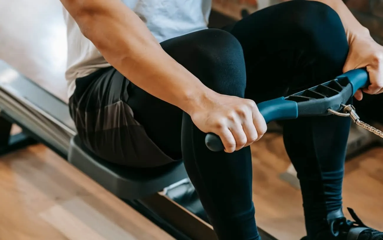 Крупный план человека's hands on a rowing machine. 